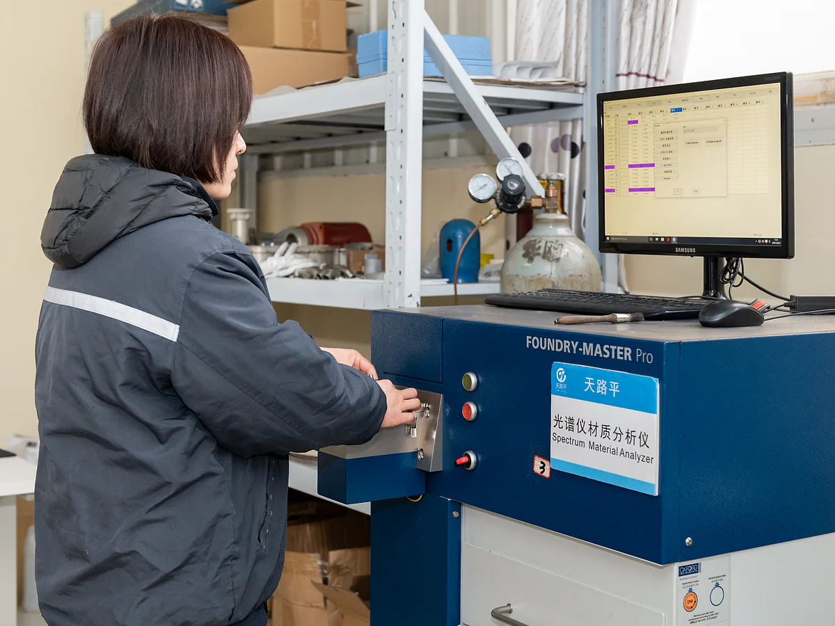 Worker reviewing material with analysis equipment