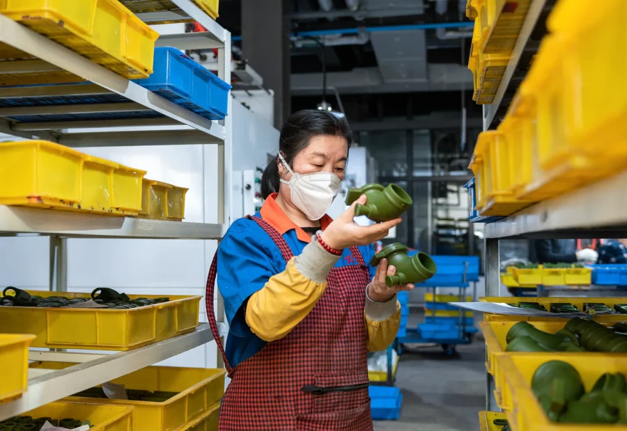 Worker visually inspecting finished cast components at Tianluping Metal