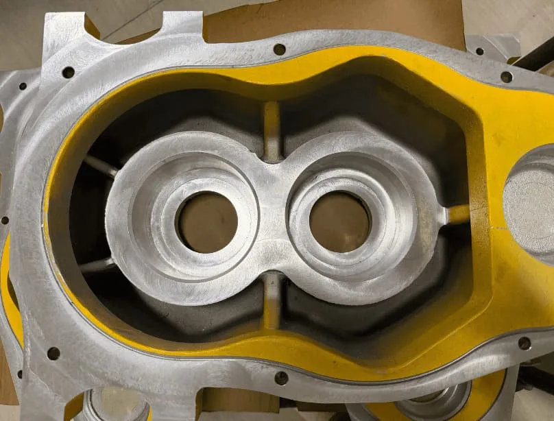 Machined bores and mounting interfaces on a die-cast equipment housing