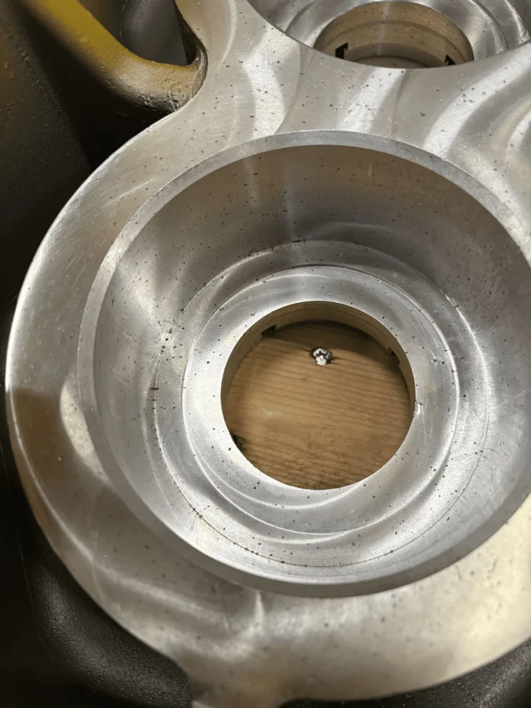 Close view of porosity indications exposed on a machined aluminum housing surface