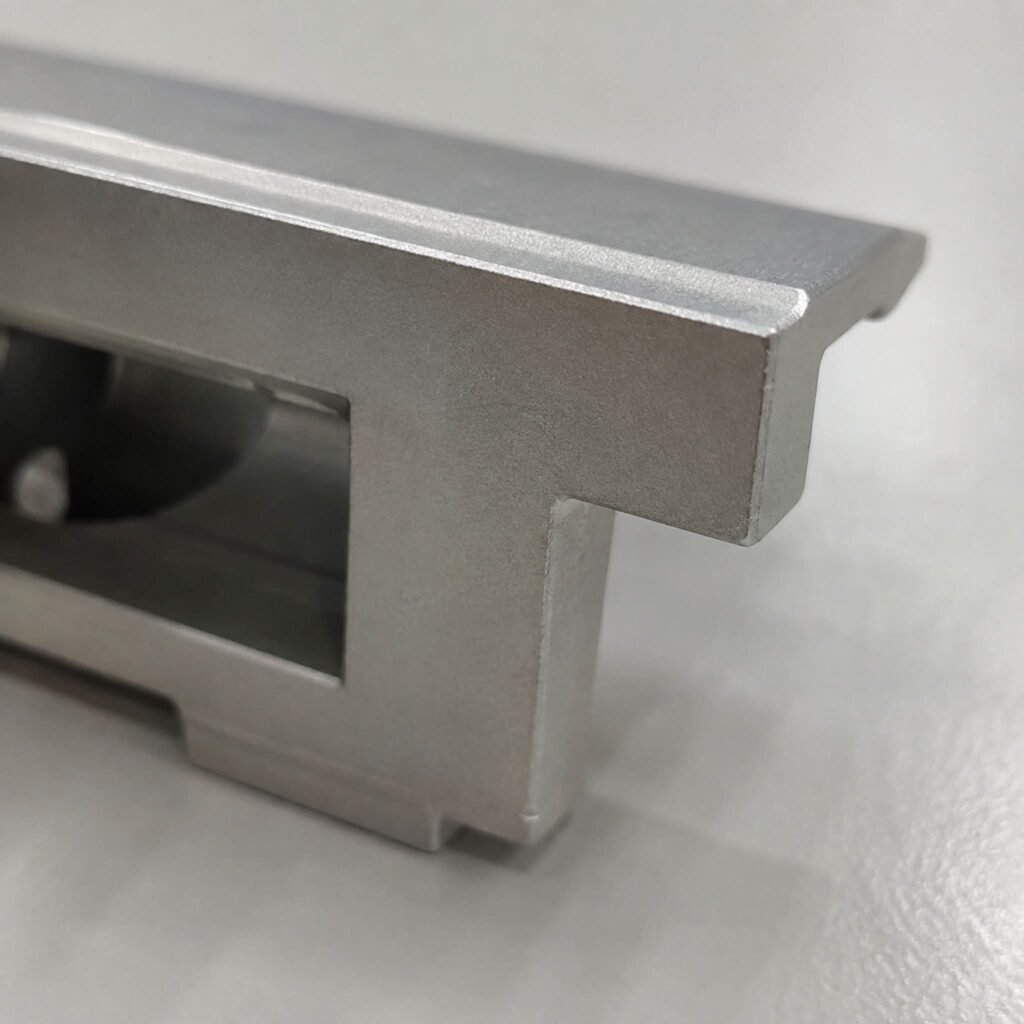 Close view of a finished edge on A380 die-cast solar mounting hardware