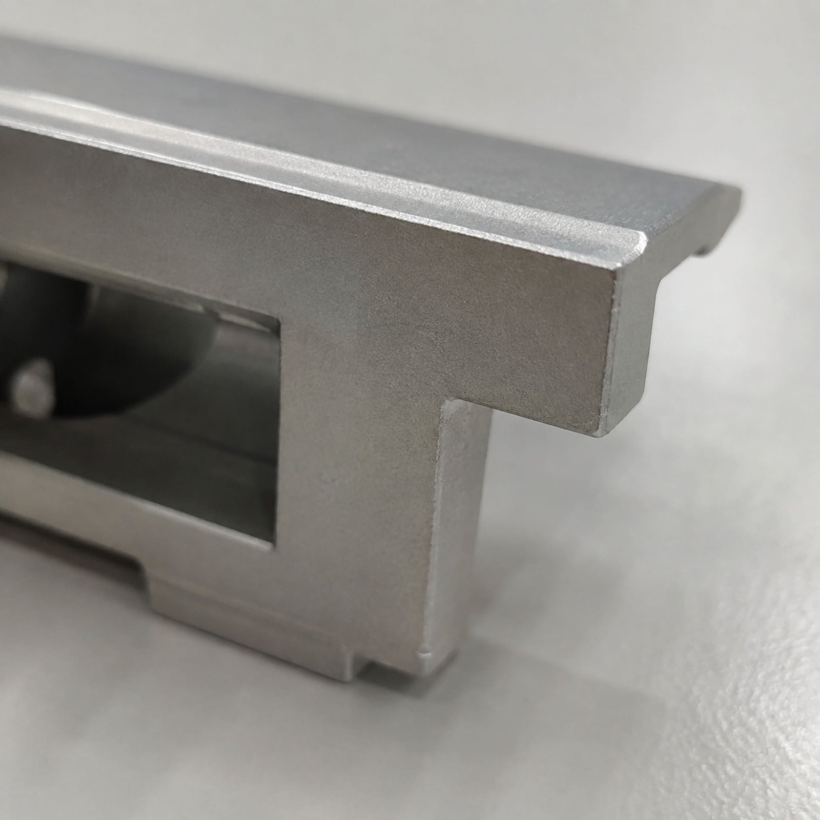 Close view of a finished edge on A380 die-cast solar mounting hardware