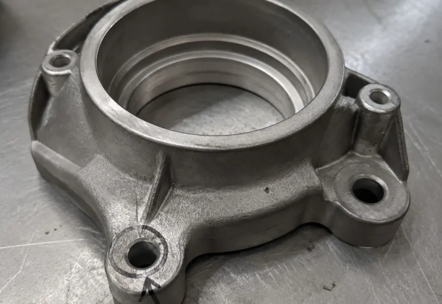 Finished ADC12 valve bracket with one assembly feature marked for dimensional review