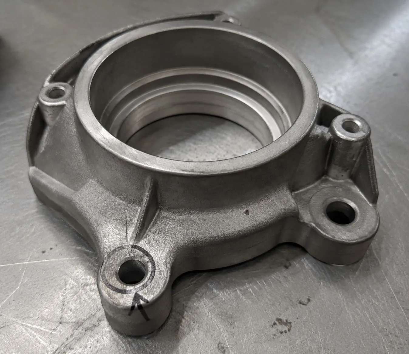Finished ADC12 valve bracket with one assembly feature marked for dimensional review