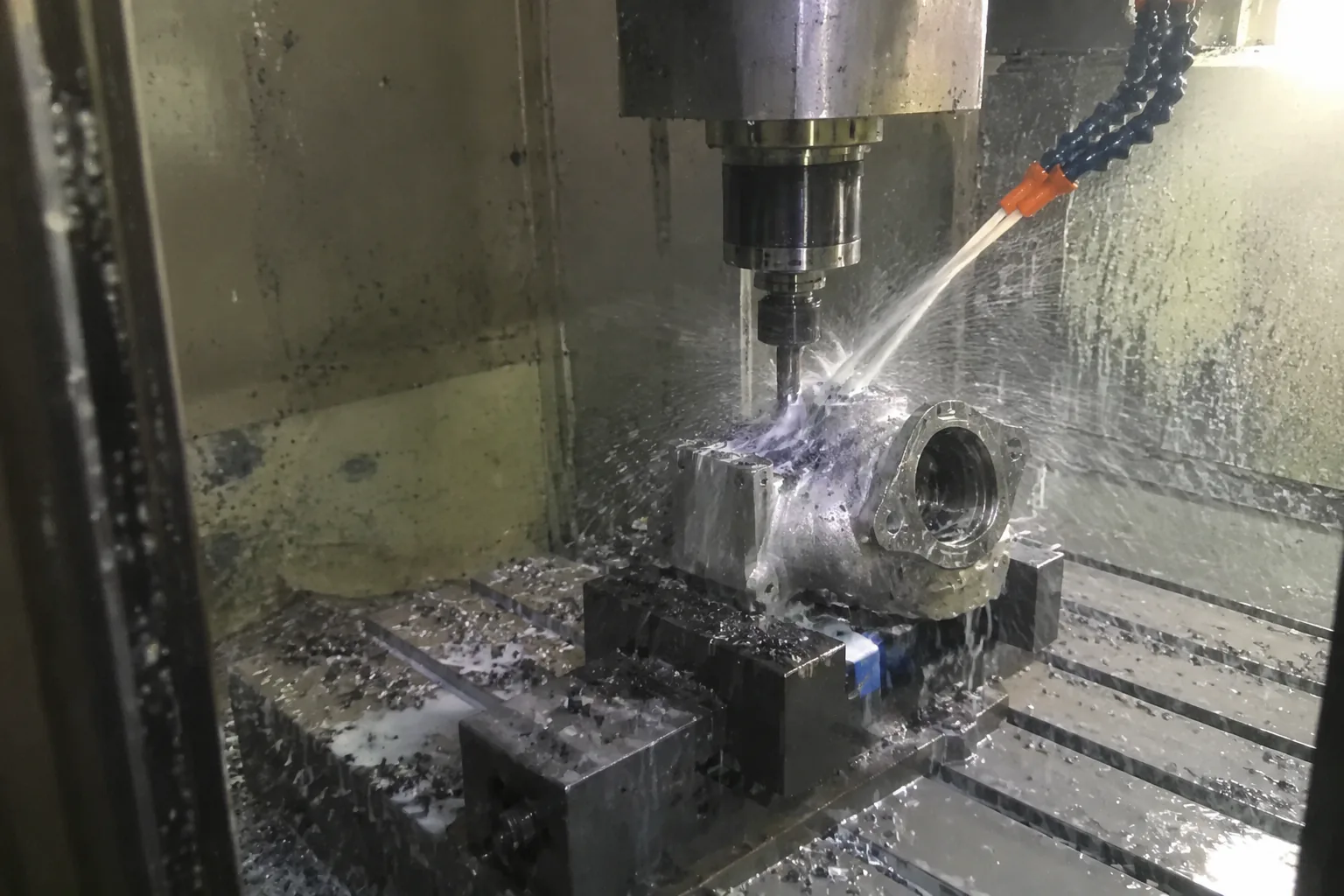 A CNC machine milling a critical face on an investment cast part held in a fixture